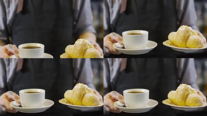 纹身咖啡师展示一杯美式羊角面包
