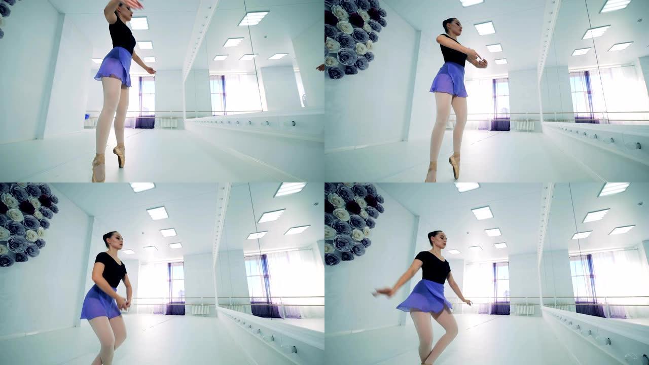 一个女孩在芭蕾舞课上跳，侧视图。