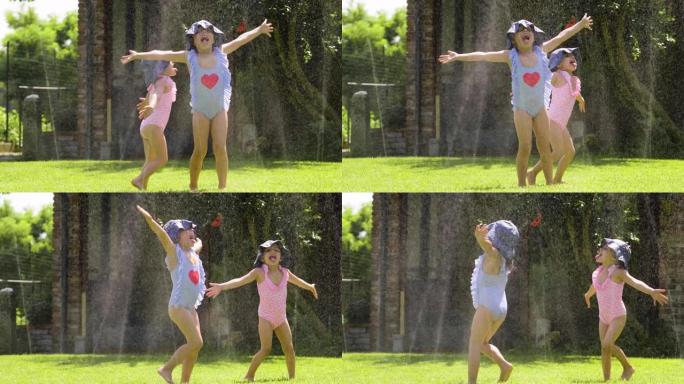 两个小女孩在花园里玩水，两个女孩奔跑，淋湿并大笑。