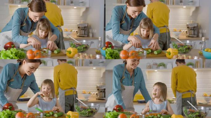 在厨房: 母亲和可爱的小女儿一起烹饪健康的晚餐。妈妈教小女孩健康的习惯，以及如何切蔬菜做沙拉。可爱的
