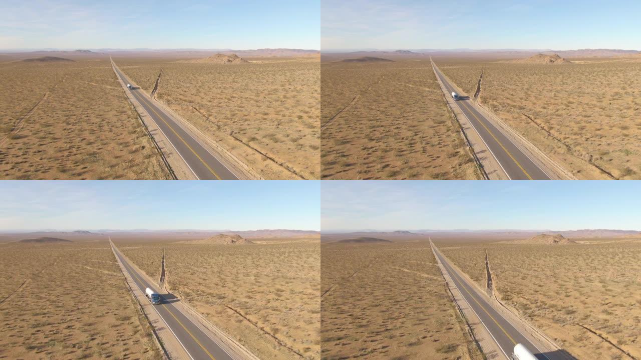空中: 在晴天，大钻机在崎Mojave的莫哈韦沙漠上拖拉水箱。