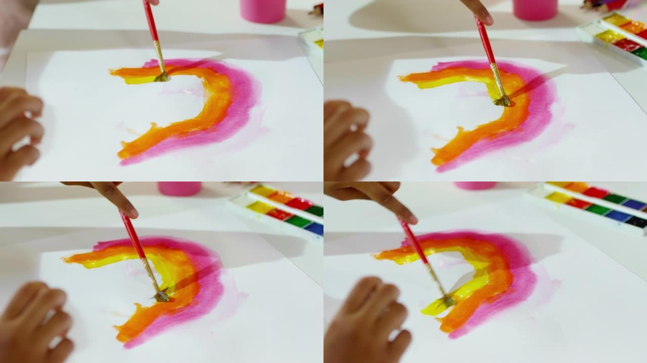 无法识别的儿童用水彩绘制彩虹
