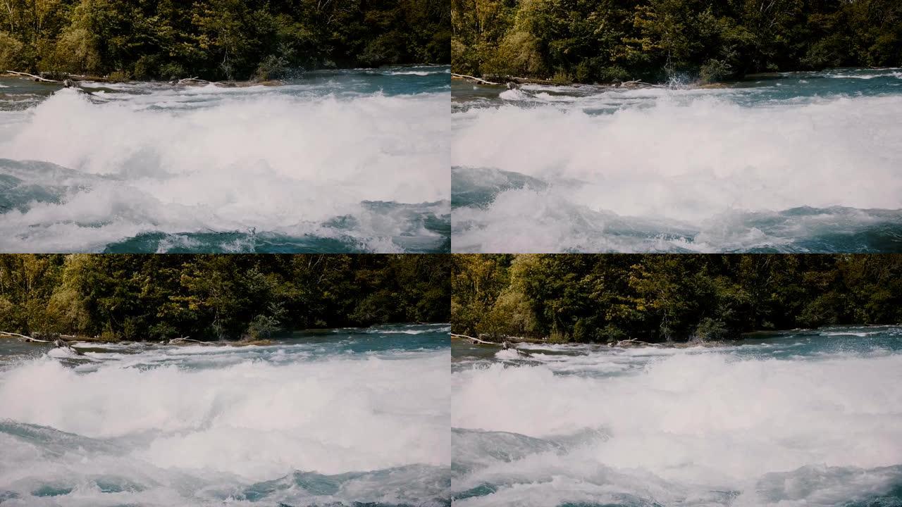 危险的快速河流急流的特写镜头，在阳光明媚的日子里，白水泡沫溅到尼亚加拉的水波上。