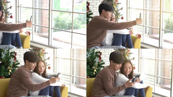 平移射击年轻的亚洲夫妇庆祝圣诞节假期并进行自拍照