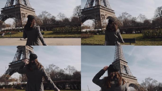 镜头跟随美丽兴奋的旅游女人跑到巴黎埃菲尔铁塔，对着镜头慢动作微笑。