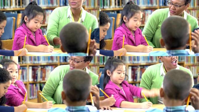 亚洲女孩，老师，同学在图书馆写作