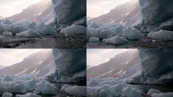 挪威一座山的冰川融化。躺在地上的冻雪融化了。水在流淌。起重机射击，UHD