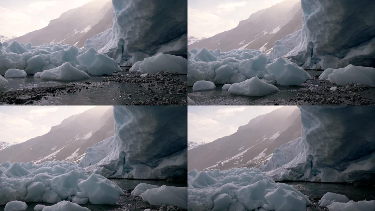 挪威一座山的冰川融化。躺在地上的冻雪融化了。水在流淌。起重机射击，UHD