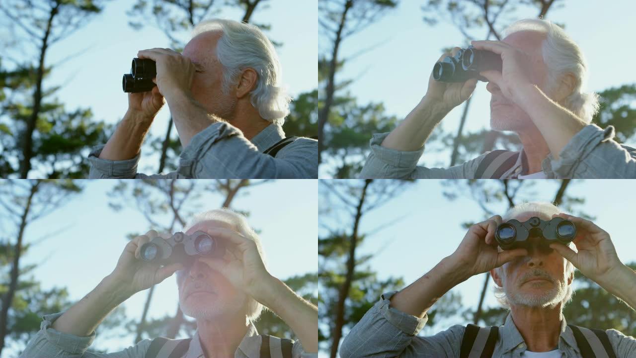 资深男子在4k乡村透过双筒望远镜看