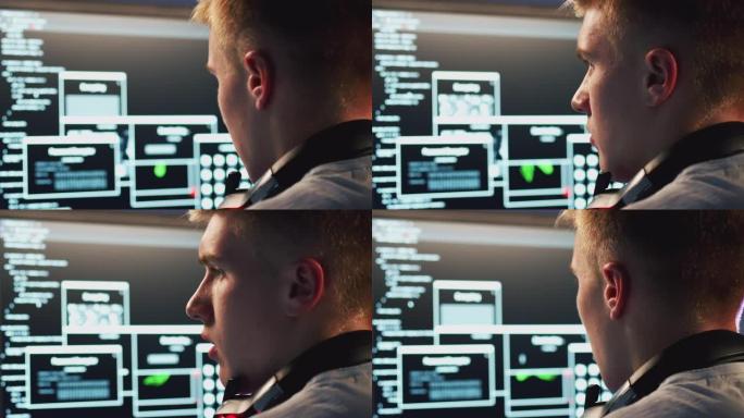 男性青少年黑客坐在计算机屏幕前绕过网络安全