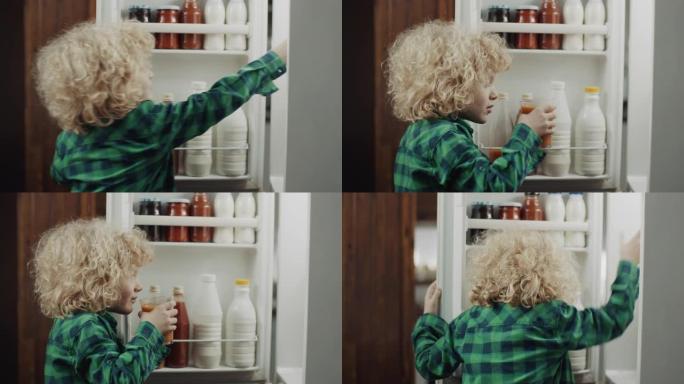 男孩在厨房喝果汁冰箱