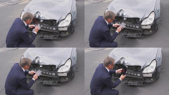 保险损失理算员用数字平板电脑拍摄汽车事故损坏的照片