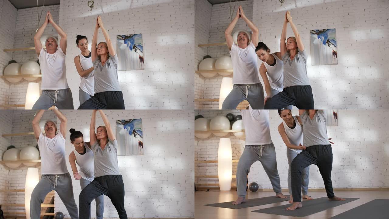 年轻的瑜伽老师为客户夫妇提供指导