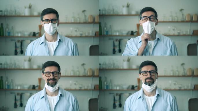 冠状病毒，新型冠状病毒肺炎概念。一个戴眼镜的男人正在摘下医用口罩并微笑着