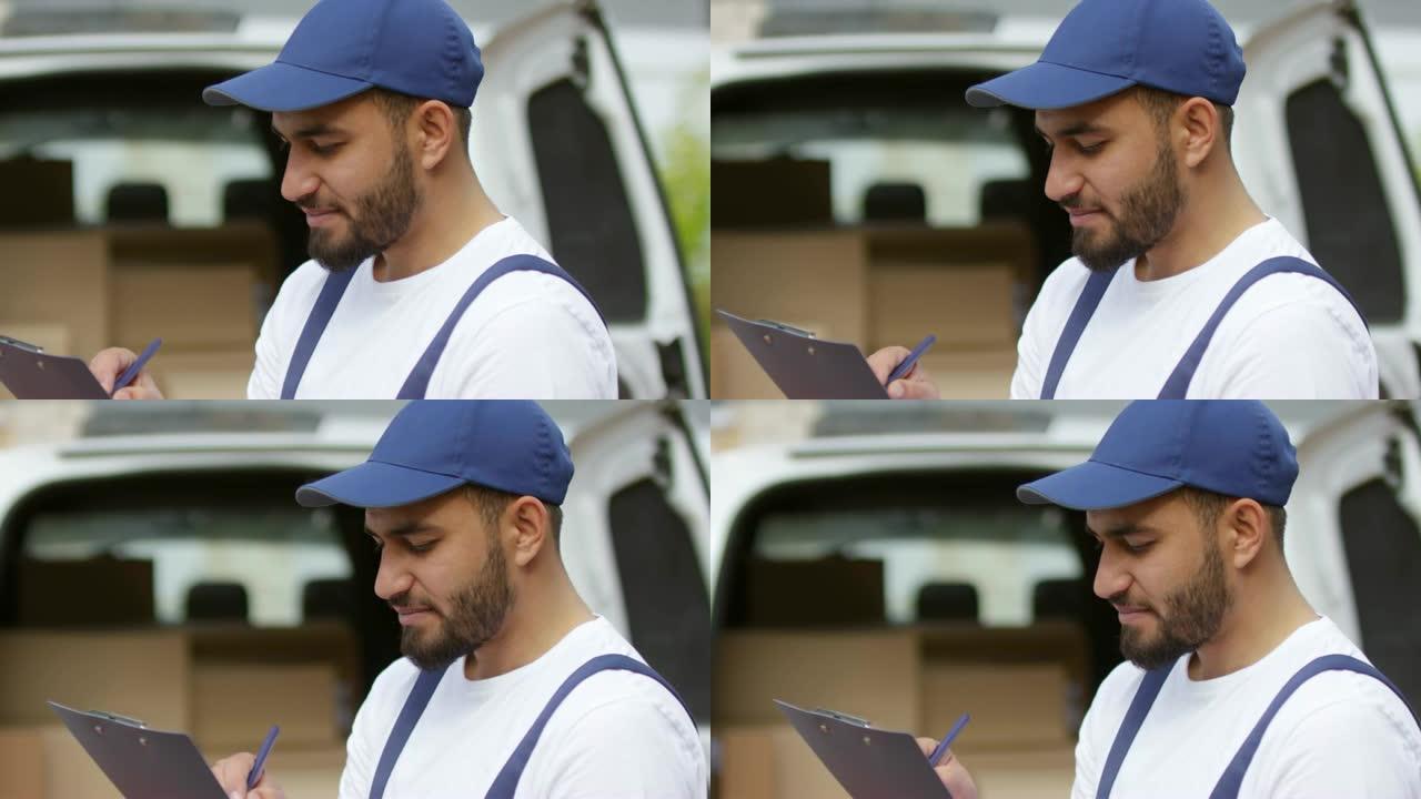 阿拉伯男性快递员在剪贴板上写字
