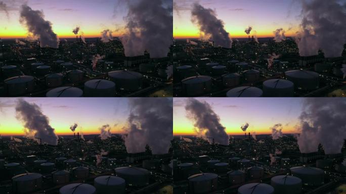 黄昏时分，WS烟雾在炼油厂和城市上空升起