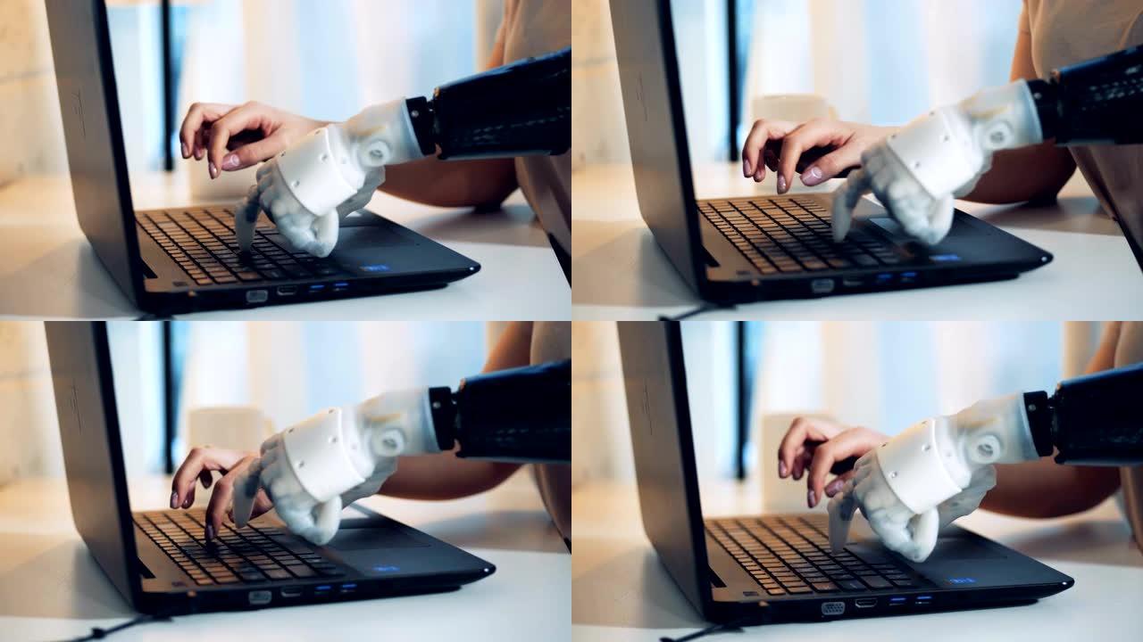 人用机械手在笔记本电脑上打字，特写。