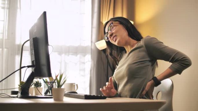 亚洲妇女背痛办公室综合症在她的办公室
