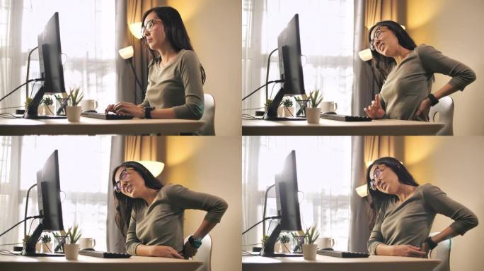 亚洲妇女背痛办公室综合症在她的办公室