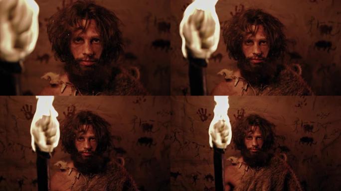 原始穴居人的肖像在晚上站在他的洞穴中，戴着兽皮，拿着火把。原始尼安德特人猎人/智人独自在夜晚。在背景