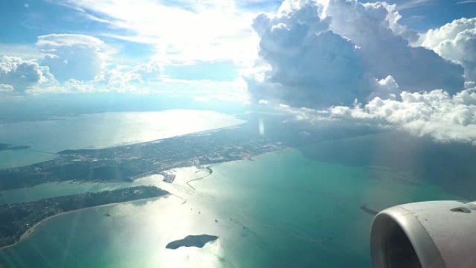 4k镜头的场景，从窗外看到美丽的山景，从空中飞过的飞机穿过云层，旅行和交通概念