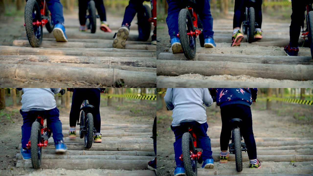 SLO MO幼儿在障碍物上骑平衡自行车。
