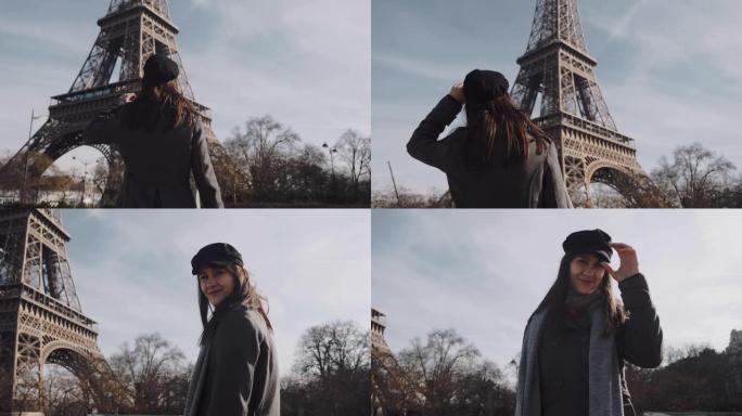 美丽快乐的旅游女人跑到巴黎埃菲尔铁塔，看着相机摆慢动作的电影动作。
