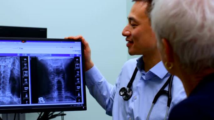 年轻的亚洲男性医生在4k诊所讨论电脑上的x光报告