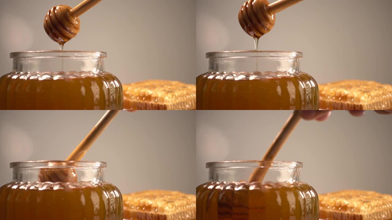 用木棍蜂蜜和蜂蜜梳子