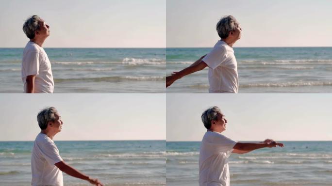 快乐的老人退休后在海滩锻炼。日落时在海滩度假做伸展运动的高级男子。真实的身体