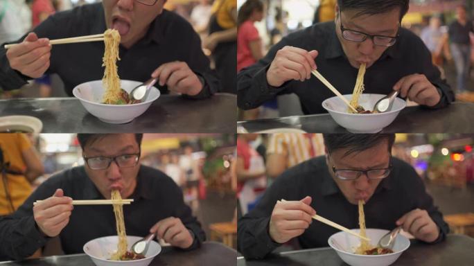 街头美食-亚洲男子在曼谷吃鸭肉面条