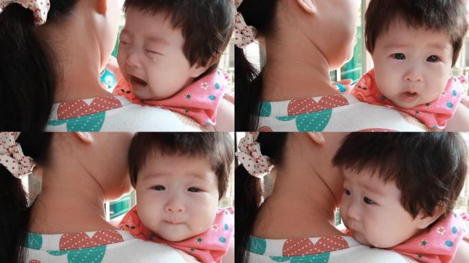 一个婴儿在母亲的怀抱中哭泣。