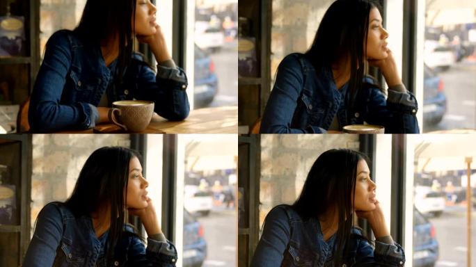 4k咖啡馆中年轻混血女子透过窗户看的前视图