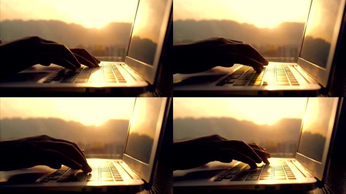 特写女人用手在阳光下在笔记本电脑上打字
