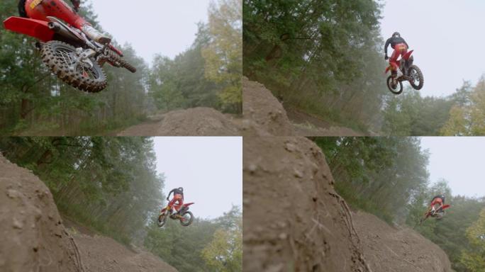 MS超级慢动作，越野摩托车骑手跳跃土墩，在树林中的泥土路线上飞行