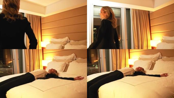 快乐的女商人在酒店房间的床上跳跃
