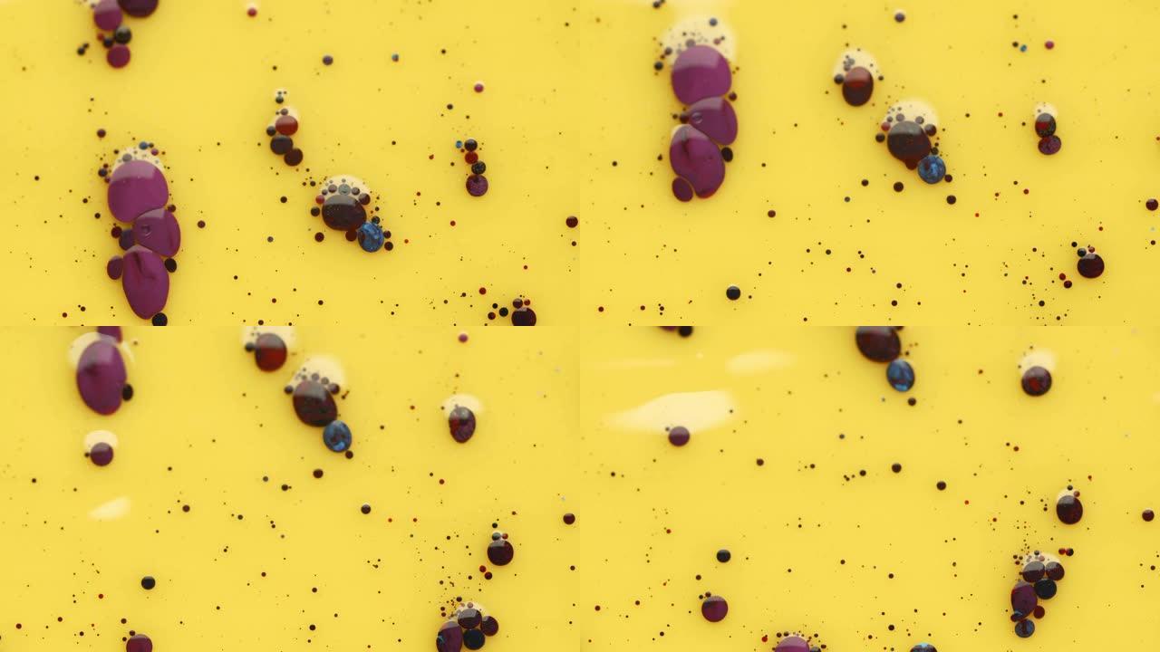 黄色背景和油上丙烯酸涂料的彩色气泡