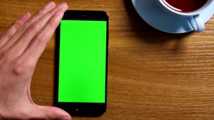 桌上绿屏智能手机点击屏幕手机特写特效