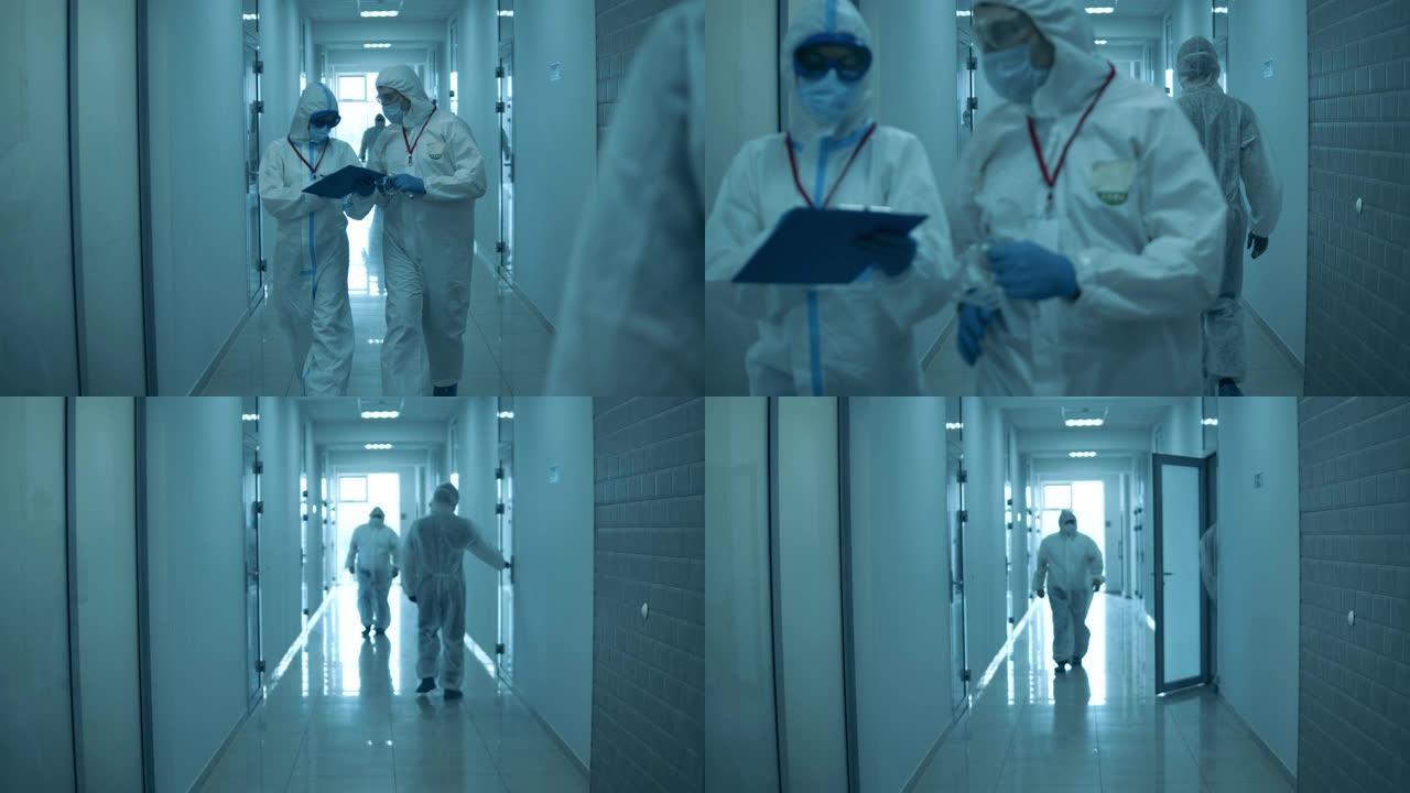 诊所工作人员穿着防烟垫走在走廊上。