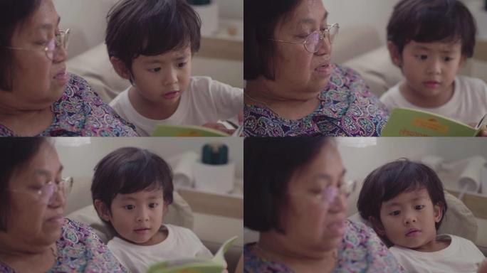 亚洲高级妇女和孙子，正在读书
