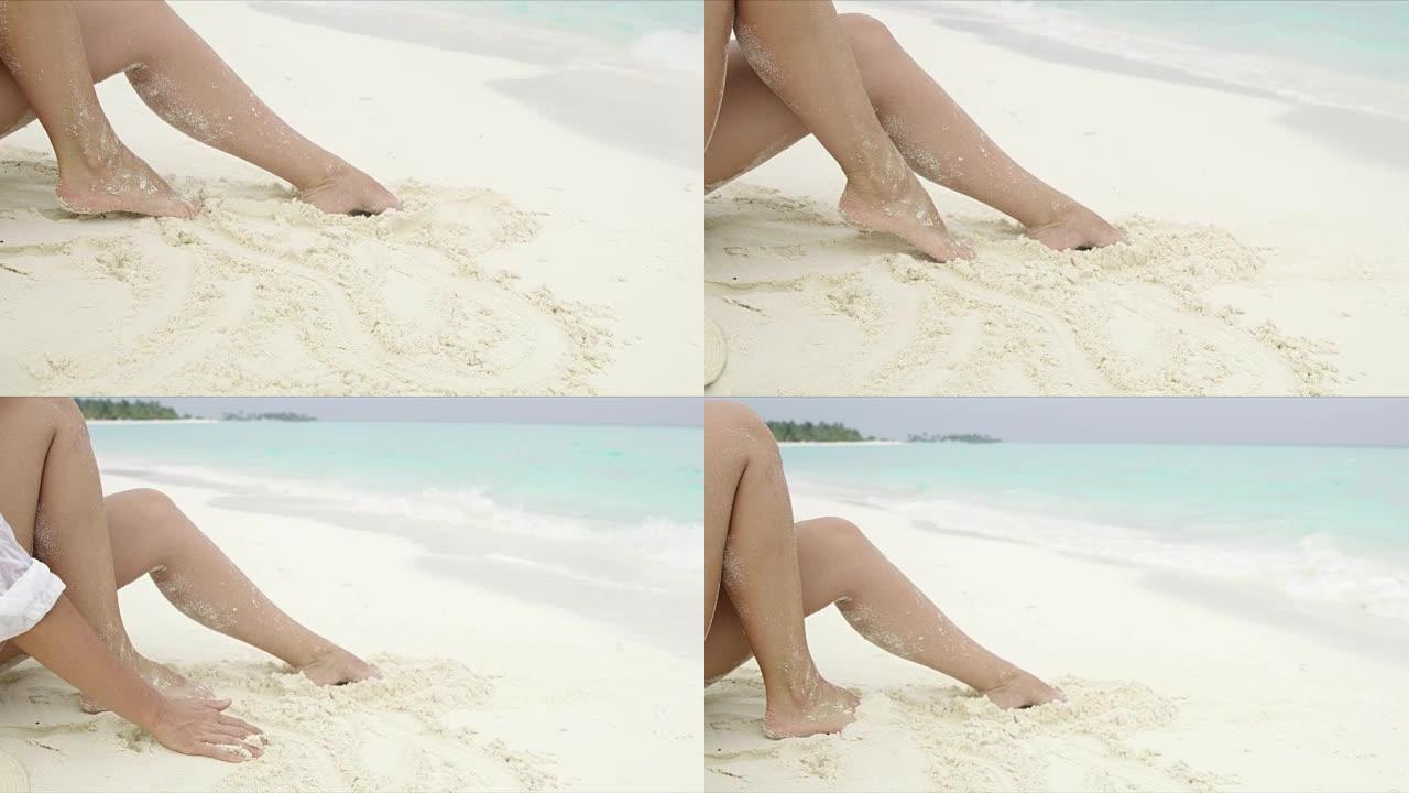 女士在马尔代夫白色沙滩上踢沙子