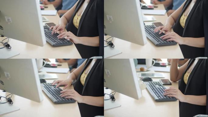 女商人在会议上在计算机键盘上打字，慢动作