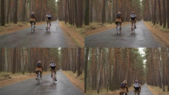 在令人讨厌的秋天，情侣骑着自行车穿过松树林