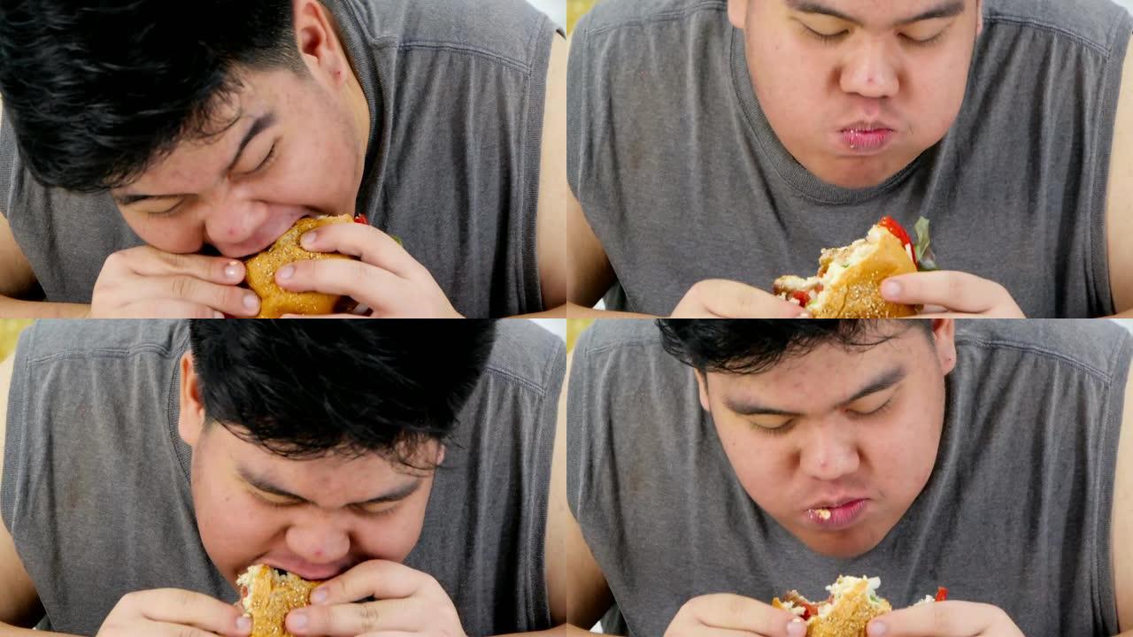 男人吃汉堡和饿男人吃的特写照片。真实的身体
