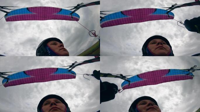 飞行滑翔伞时关闭女人的脸