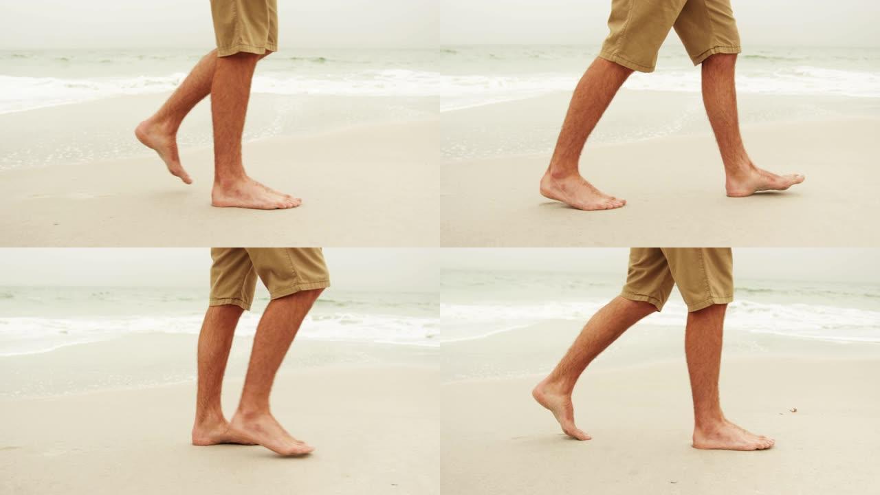 低矮的男人赤脚在海滩上行走4k