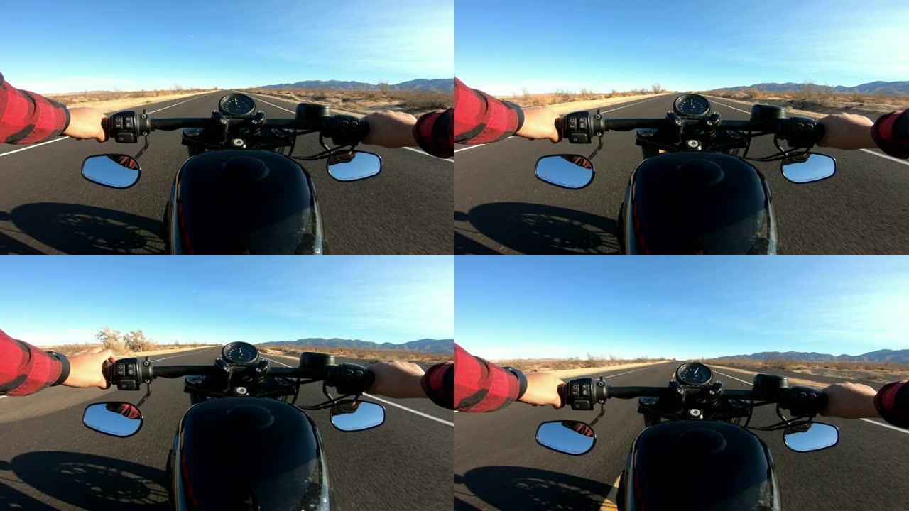男子骑摩托车沿着沙漠直道行驶的视点