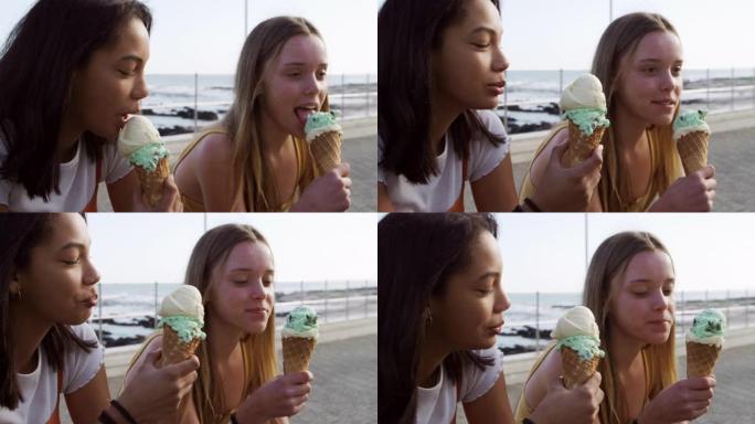 高加索人和混血女孩在海边吃冰淇淋的侧视图