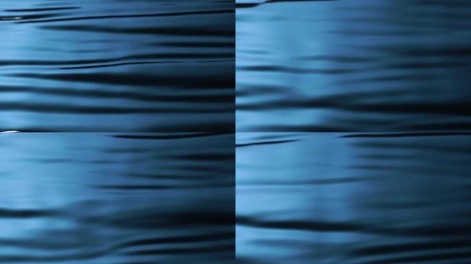 慢动作: 浅蓝色背景的水波图案。