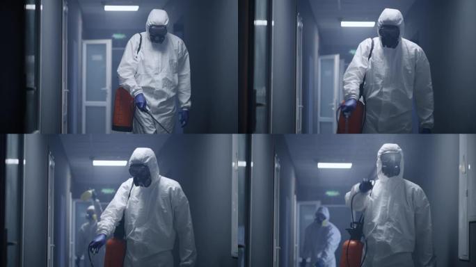 穿着防护服消毒建筑物的男人
